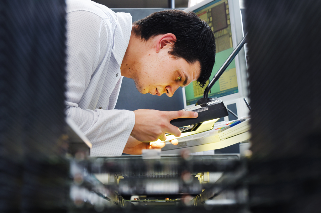 Engineer inspecting electronics